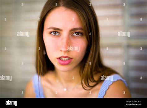 Close Up Portrait Of Teenage Girl Leaning Against Art Deco Glass Brick