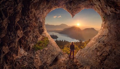 Young Woman In Heart Shape Cave Towards The Idyllic Sunrise Live The