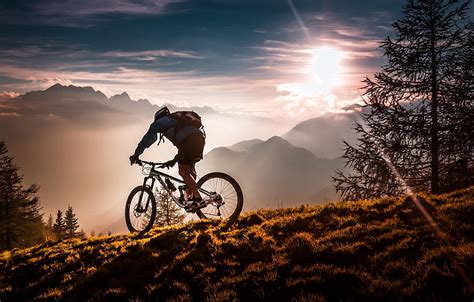 Man Riding Mountain Bike Under Sunset Hd Wallpaper Wallpaper Flare