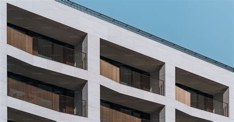 A Tall White Building With Balconies And Balconies Photo Residential