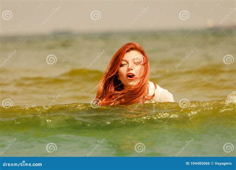 Redhead Woman Playing In Water During Summertime Stock Photo Image Of