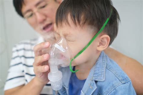 Premium Photo Asian Father Helping His Toddler Son With Inhalation