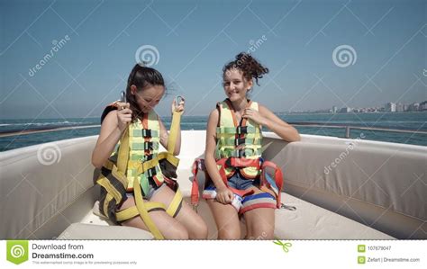 Two Happy Teen Girls Have Fun On Ride With Luxury Yacht Stock Image