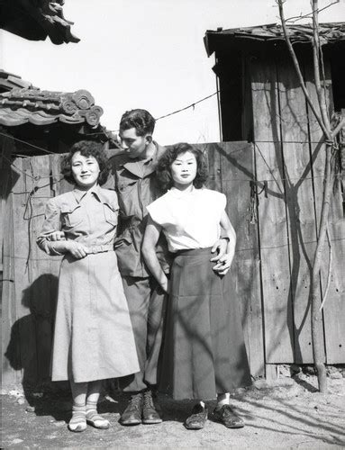 soldier posing with two women at a korean brothel — calisphere