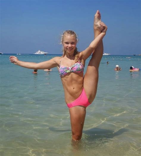 Cheer Cheerleader Doing Heel Stretch Stunt At The Beach Ocean Blue Sky Grace Form Athletic Pink