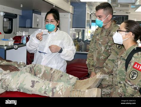 A Laboratory Technician With The Armed Services Blood Program Instructs