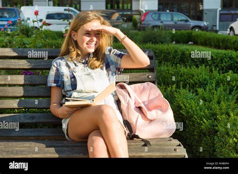 Outdoors Portrait Of Teenage Schoolgirl 13 14 Years Old Sitting On