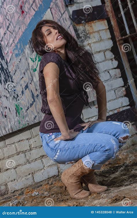 A Lovely Brunette Model Posing Outdoors With The Latest Fashions Stock