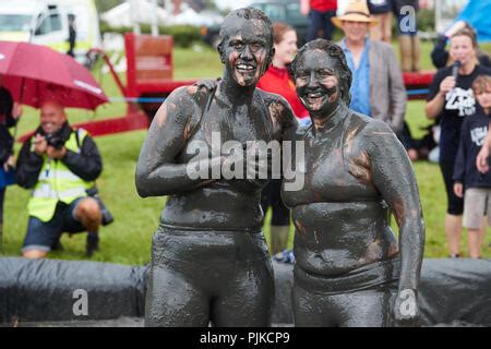 Two Women Mud Wrestling At A Mud Fighting Competition At The LowLand