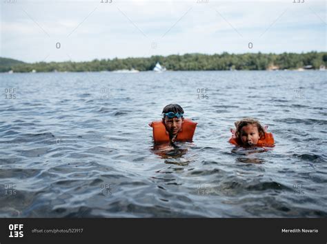 Two Young Children Swimming In A Lake Stock Photo Offset