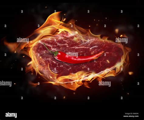 Concept Of Burning Raw Beef Steak Isolated On Black Background Stock