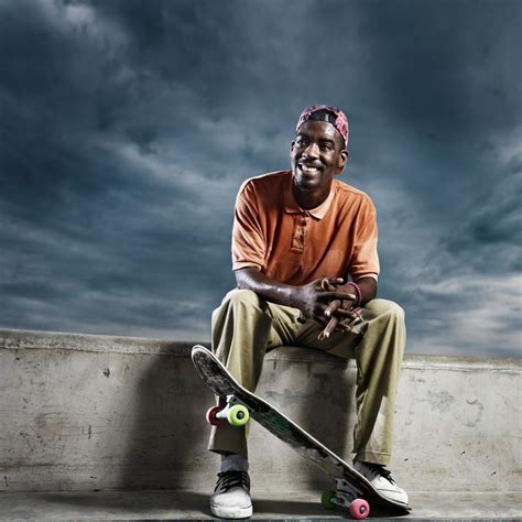 Cool African Skate Boarder Sitting Down To Rest Skateboard Pictures