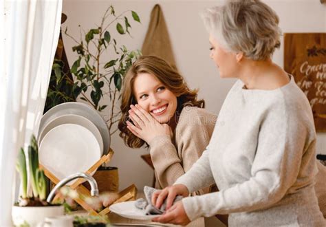 Happy Mother And Daughtertalk In The Kitchen While Washing Dishes At Home Stock Image Image Of