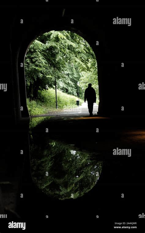 Man Walking Through Tunnel Stock Photo Alamy