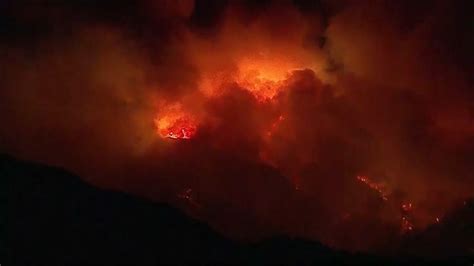 Smoke And Flames From Wildfire Rise Into Night Sky