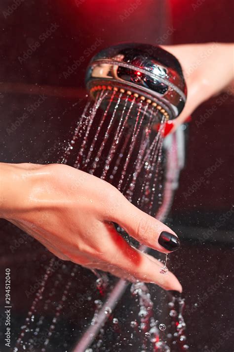 Two Lesbian Girls In The Shower Shower Head With Pouring Water And A Female Hand Stock Photo