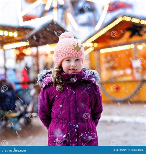 Little Cute Kid Girl Having Fun On Traditional German Christmas Market