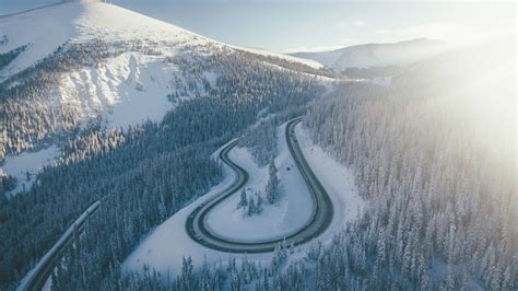 Aerial View Of Mountain Road And Snow Covered Mountain