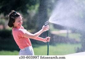 Woman Sprayed With Water From A Hose Stock Image X Fotosearch