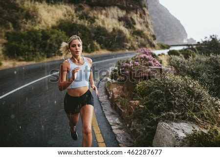 Fitness Woman Running On Highway Around The Mountains Female Athlete