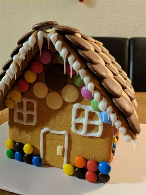 A Gingerbread House Decorated With Candy And Icing