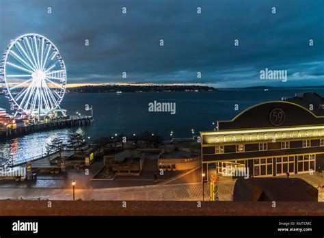 The Seattle Downtown Waterfront At Dusk With The Ferris Wheel And