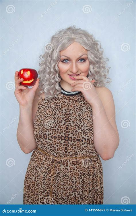 Chubby Blonde Girl Wearing Summer Dress And Posing With Big Red Apple On White Background Alone