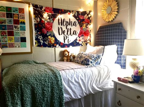 There Is A Bed That Has Been Decorated With Flowers On The Headboard And Pillows