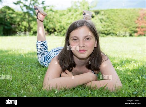 Pretty Smiling Pre Teen Girl Lying In Grass Stock Photo Alamy
