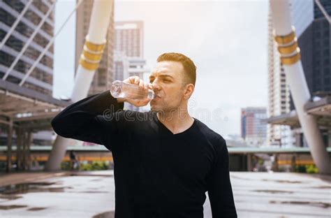 Man Drinking Water After Running Exercise At The City Stock Image