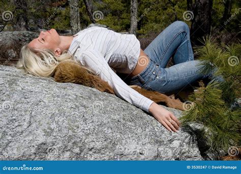 Young Woman Lying On Her Back And Stretching Royalty Free Stock Image