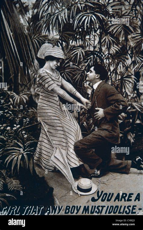 Man Kneeling Before Woman In Greenhouse Circa 1911 Stock Photo Alamy