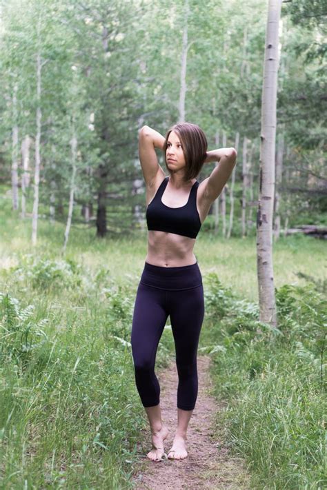 A Woman In Black Sports Bra Top And Leggings Standing On Dirt Path Next