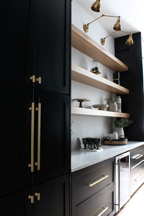 Black Cabinetry With Gold Colored Harware And Accents Light Wood