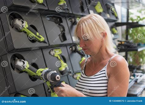 Blond Woman Is Viewing A Drill At Hardware Store Stock Image Image Of Portrait Buying