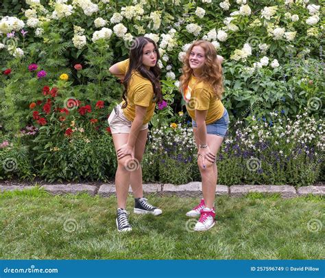 Amerasian Teenage Girl And Her Caucasian Cousin In A Fun Pose Before A