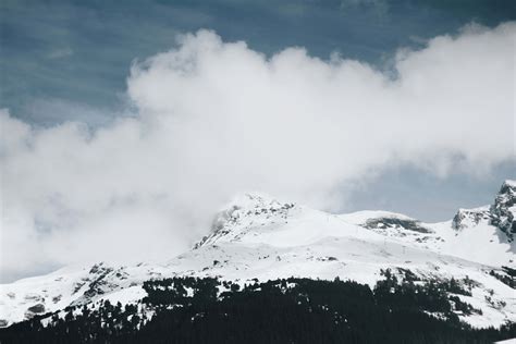 Cloud Snow Covered Mountain Under Cloudy Sky During Daytime Mountain