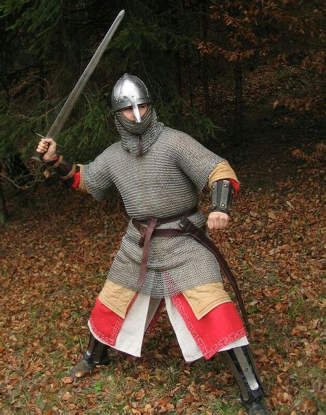 A Man Dressed As A Knight Holding Two Swords