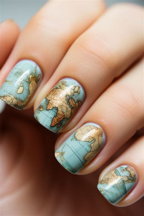 A Womans Hand With A Blue And Gold Manicure Holding A World Map