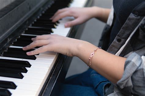 Close Up Of The Hands Of A Teenage Girl Playing Piano
