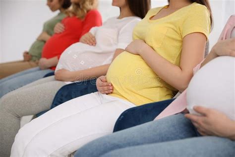 Group Of Pregnant Women At Courses For Expectant Mothers On Blurred Background Stock Image