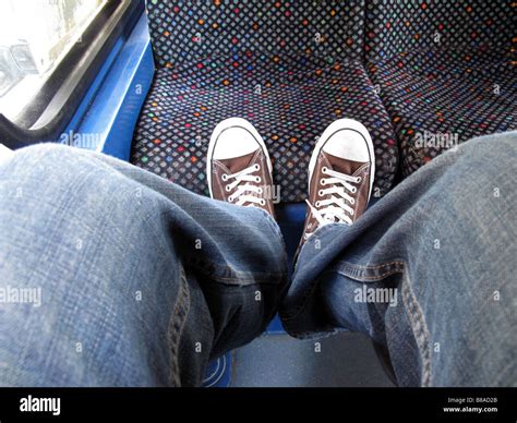Feet Resting On Bus Seat Stock Photo Alamy