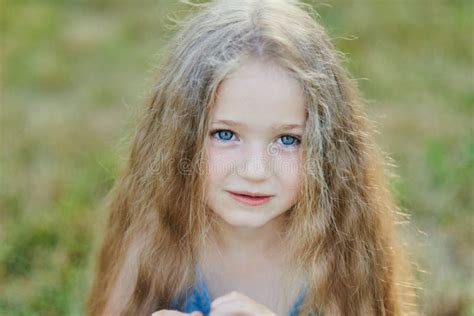 Close Up Portrait Of Pretty Young Blue Eyed Fair Skinned Girl With Happy And Peaceful