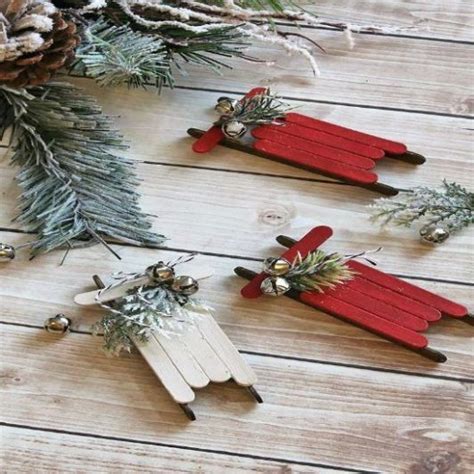 Two Red And White Popsicle Christmas Decorations On Wooden Planks With