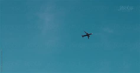 Airplane Flying In Blue Sky By Danil Nevsky Stocksy United