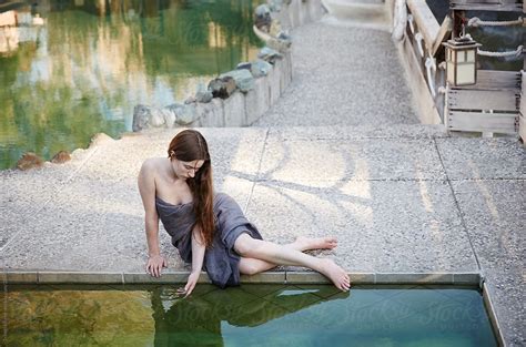 Woman Relaxing At Japanese Hot Springs Spa By Pool By Stocksy