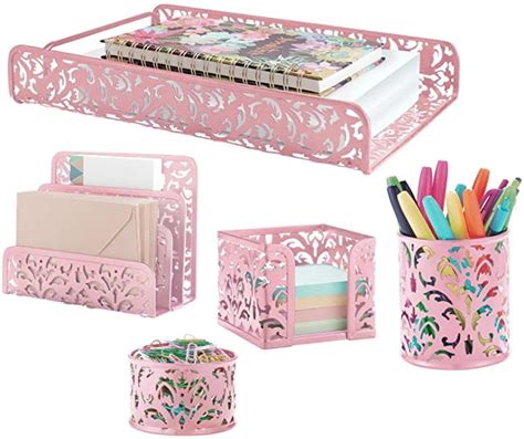 Pink Desk Accessories Including Pens Pencils And Magazines Are Shown