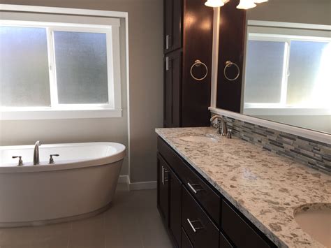 This Master Suite Features A Free Standing Tub And Quartz Counter Tops