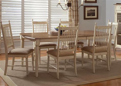 These are well paired with the colorful patterned area rug that adds a dash of color to the light hardwood flooring. Cottage Cove Ivory Finish Casual Dining Room Set