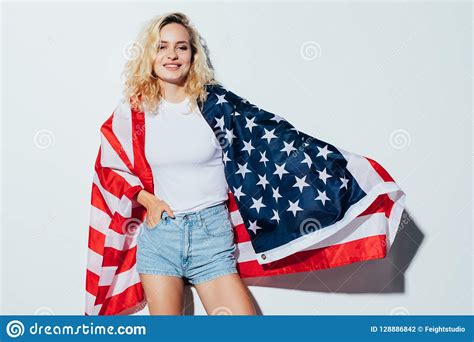 American Blonde Woman Holding The Usa Flag Isolated Over A White
